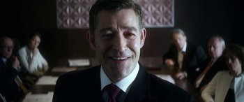 Movie still from “Mayhem” (2017), directed by Joe Lynch – A person wearing a suit and tie; Close Up shot, Over the shoulder angle