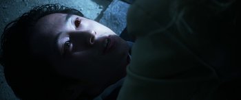 Movie still from “Mayhem” (2017), directed by Joe Lynch – A man laying on the ground with his eyes closed; Extreme Close Up shot, Overhead angle