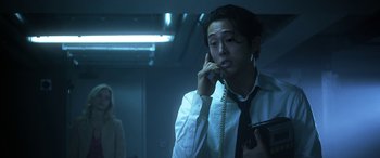 Movie still from “Mayhem” (2017), directed by Joe Lynch – A man talking on a phone while holding a gun; Close Up shot, Low angle