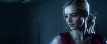 Movie still from “Mayhem” (2017), directed by Joe Lynch – A young woman with red eye makeup and a piercing; Close Up shot, Over the shoulder angle
