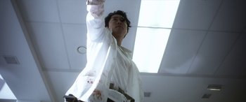 Movie still from “Mayhem” (2017), directed by Joe Lynch – A man in a white shirt is holding a knife; Medium shot, Low angle