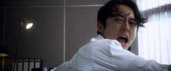 Movie still from “Mayhem” (2017), directed by Joe Lynch – A man with his mouth wide open in a bathroom; Close Up shot, Low angle