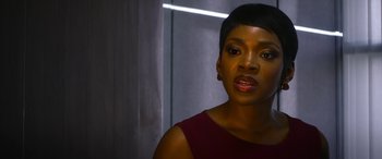 Movie still from “Mayhem” (2017), directed by Joe Lynch – A woman in a red dress is looking at the camera; Close Up shot, Over the shoulder angle