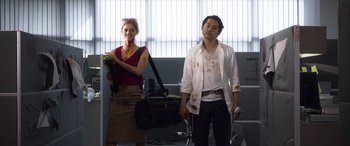 Movie still from “Mayhem” (2017), directed by Joe Lynch – A man and a woman standing next to each other in a room; Medium shot, Low angle