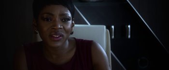 Movie still from “Mayhem” (2017), directed by Joe Lynch – A person sitting in a chair; Close Up shot, Over the shoulder angle