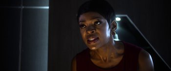 Movie still from “Mayhem” (2017), directed by Joe Lynch – A woman with short black hair is looking at the camera; Close Up shot, Low angle