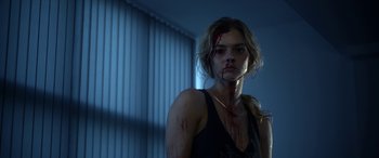 Movie still from “Mayhem” (2017), directed by Joe Lynch – A woman with blood all over her face and neck; Close Up shot, Over the shoulder angle