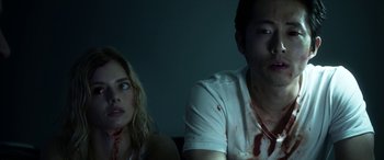 Movie still from “Mayhem” (2017), directed by Joe Lynch – A man and a woman sitting next to each other; Close Up shot, Low angle