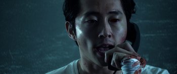 Movie still from “Mayhem” (2017), directed by Joe Lynch – A person talking on a cell phone; Close Up shot, High angle