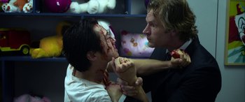 Movie still from “Mayhem” (2017), directed by Joe Lynch – Two men fighting with each other with blood on their face; Close Up shot, Over the shoulder angle