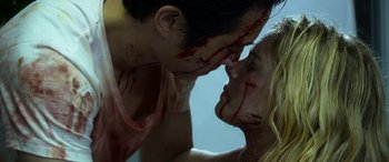 Movie still from “Mayhem” (2017), directed by Joe Lynch – A couple of people that are covered in fake blood; Close Up shot, Over the shoulder angle