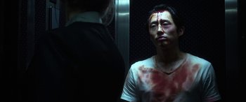 Movie still from “Mayhem” (2017), directed by Joe Lynch – A man with blood all over his face and head; Close Up shot, Over the shoulder angle