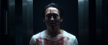 Movie still from “Mayhem” (2017), directed by Joe Lynch – A man with blood all over his face; Close Up shot, Overhead angle