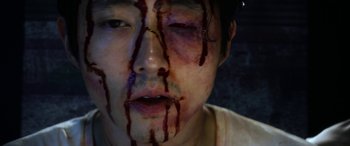 Movie still from “Mayhem” (2017), directed by Joe Lynch – A person with blood on his face; Extreme Close Up shot, Overhead angle