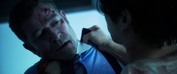 Movie still from “Mayhem” (2017), directed by Joe Lynch – A man with a broken arm is being helped by a woman; Close Up shot, Over the shoulder angle