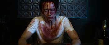 Movie still from “Mayhem” (2017), directed by Joe Lynch – A man with blood all over his face and chest; Medium shot, High angle