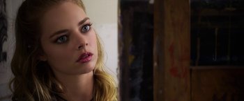 Movie still from “Mayhem” (2017), directed by Joe Lynch – A woman's face in a room; Close Up shot, Over the shoulder angle