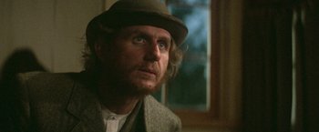 Movie still from “McCabe & Mrs. Miller” (1971), directed by Robert Altman – A person wearing a hat; Close Up shot, Over the shoulder angle