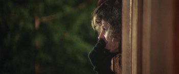 Movie still from “McCabe & Mrs. Miller” (1971), directed by Robert Altman – A woman with curly brown hair wearing a black scarf; Close Up shot, Over the shoulder angle