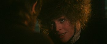 Movie still from “McCabe & Mrs. Miller” (1971), directed by Robert Altman – A woman's face in the dark; Close Up shot, Over the shoulder angle