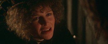 Movie still from “McCabe & Mrs. Miller” (1971), directed by Robert Altman – A person with curly brown hair; Close Up shot, Over the shoulder angle