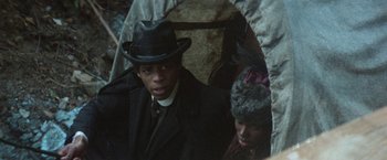 Movie still from “McCabe & Mrs. Miller” (1971), directed by Robert Altman – A man and a woman wearing hats and coats; Close Up shot, Low angle