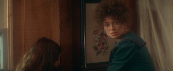 Movie still from “McCabe & Mrs. Miller” (1971), directed by Robert Altman – A woman with a curly hair sits in front of a mirror; Close Up shot, Over the shoulder angle