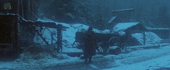Movie still from “McCabe & Mrs. Miller” (1971), directed by Robert Altman – A man standing in front of a horse drawn carriage; Wide shot, Low angle
