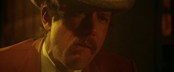 Movie still from “McCabe & Mrs. Miller” (1971), directed by Robert Altman – A person wearing a cowboy hat; Close Up shot, Low angle