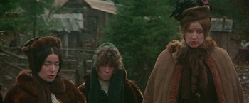 Movie still from “McCabe & Mrs. Miller” (1971), directed by Robert Altman – A woman in a green coat and a green scarf; Medium shot, Low angle