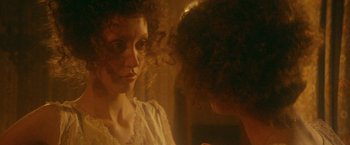 Movie still from “McCabe & Mrs. Miller” (1971), directed by Robert Altman – A woman looking at her reflection in a mirror; Close Up shot, Over the shoulder angle