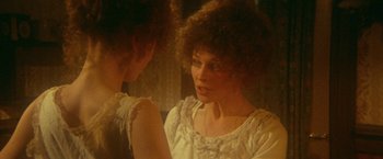 Movie still from “McCabe & Mrs. Miller” (1971), directed by Robert Altman – A woman looking at her reflection in a mirror; Close Up shot, Over the shoulder angle