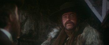 Movie still from “McCabe & Mrs. Miller” (1971), directed by Robert Altman – A person wearing a hat; Close Up shot, Low angle