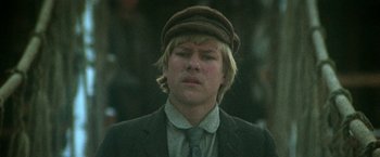 Movie still from “McCabe & Mrs. Miller” (1971), directed by Robert Altman – A young man wearing a hat and a suit; Close Up shot, Low angle