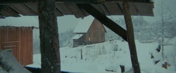 Movie still from “McCabe & Mrs. Miller” (1971), directed by Robert Altman – A cabin in the woods with snow on the ground; Extreme Wide shot, Low angle