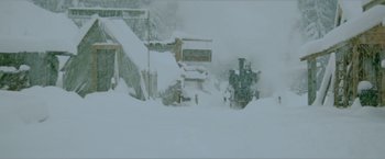 Movie still from “McCabe & Mrs. Miller” (1971), directed by Robert Altman – A train traveling down a snow covered track; Extreme Wide shot, Low angle