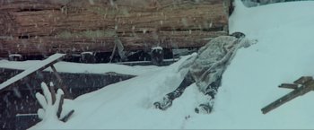 Movie still from “McCabe & Mrs. Miller” (1971), directed by Robert Altman – A person is laying in the snow on skis; Wide shot, Low angle