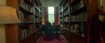 Movie still from “Me and Earl and the Dying Girl” (2015), directed by Alfonso Gomez-Rejon – People sitting in a room with bookshelves and a window; Wide shot, High angle