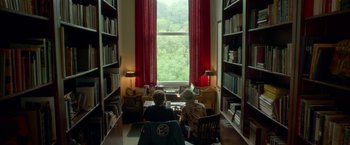 Movie still from “Me and Earl and the Dying Girl” (2015), directed by Alfonso Gomez-Rejon – Two people sitting at a table in front of a large window; Wide shot, Over the shoulder angle