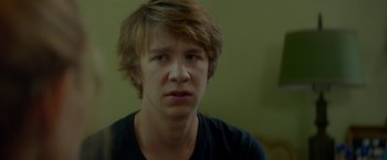 Movie still from “Me and Earl and the Dying Girl” (2015), directed by Alfonso Gomez-Rejon – A young man with brown hair wearing a black t - shirt; Close Up shot, Over the shoulder angle