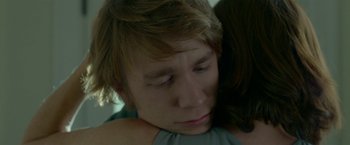 Movie still from “Me and Earl and the Dying Girl” (2015), directed by Alfonso Gomez-Rejon – A person holding another person's shoulder; Close Up shot, Low angle