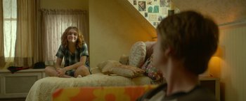 Movie still from “Me and Earl and the Dying Girl” (2015), directed by Alfonso Gomez-Rejon – Two young people sitting on a bed in a room; Medium shot, Over the shoulder angle