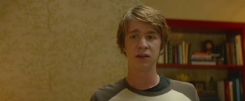 Movie still from “Me and Earl and the Dying Girl” (2015), directed by Alfonso Gomez-Rejon – A young man is looking into the camera; Close Up shot, Over the shoulder angle