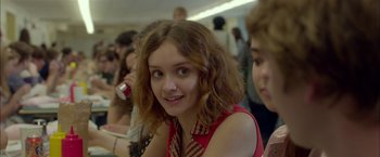 Movie still from “Me and Earl and the Dying Girl” (2015), directed by Alfonso Gomez-Rejon – A young girl is smiling for the camera; Close Up shot, Over the shoulder angle