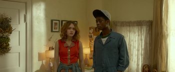 Movie still from “Me and Earl and the Dying Girl” (2015), directed by Alfonso Gomez-Rejon – A man and a woman standing next to each other in a room; Medium shot, Over the shoulder angle