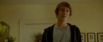 Movie still from “Me and Earl and the Dying Girl” (2015), directed by Alfonso Gomez-Rejon – A young man standing in front of a wall; Medium shot, Over the shoulder angle