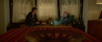 Movie still from “Me and Earl and the Dying Girl” (2015), directed by Alfonso Gomez-Rejon – A man and a woman sitting on the floor with a laptop in front of them; Wide shot, Over the shoulder angle