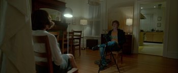 Movie still from “Me and Earl and the Dying Girl” (2015), directed by Alfonso Gomez-Rejon – Two people sitting in a living room with a video camera; Wide shot, Over the shoulder angle