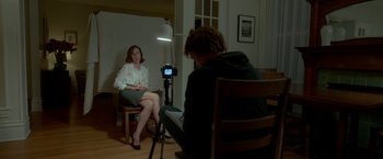 Movie still from “Me and Earl and the Dying Girl” (2015), directed by Alfonso Gomez-Rejon – A woman sitting on a chair in front of a camera; Medium shot, Over the shoulder angle