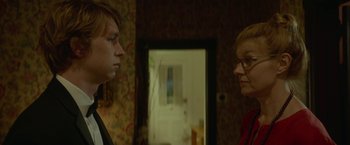 Movie still from “Me and Earl and the Dying Girl” (2015), directed by Alfonso Gomez-Rejon – A man and a woman standing next to each other in a room; Close Up shot, Low angle